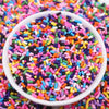 A white bowl filled with colorful polymer clay slice sprinkles for slime and DIY crafts