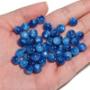 A handful of vibrant blue tiger eye resin beads for jewelry making