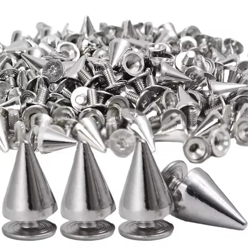 A pile of silver punk cone spike rivets for DIY fashion accessories.