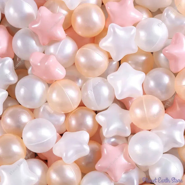 A close-up of a pile of colorful, iridescent play balls in shades of pink, white, and peach.