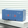 A blue industrial storage box labeled WAN HAI resting on a white book.