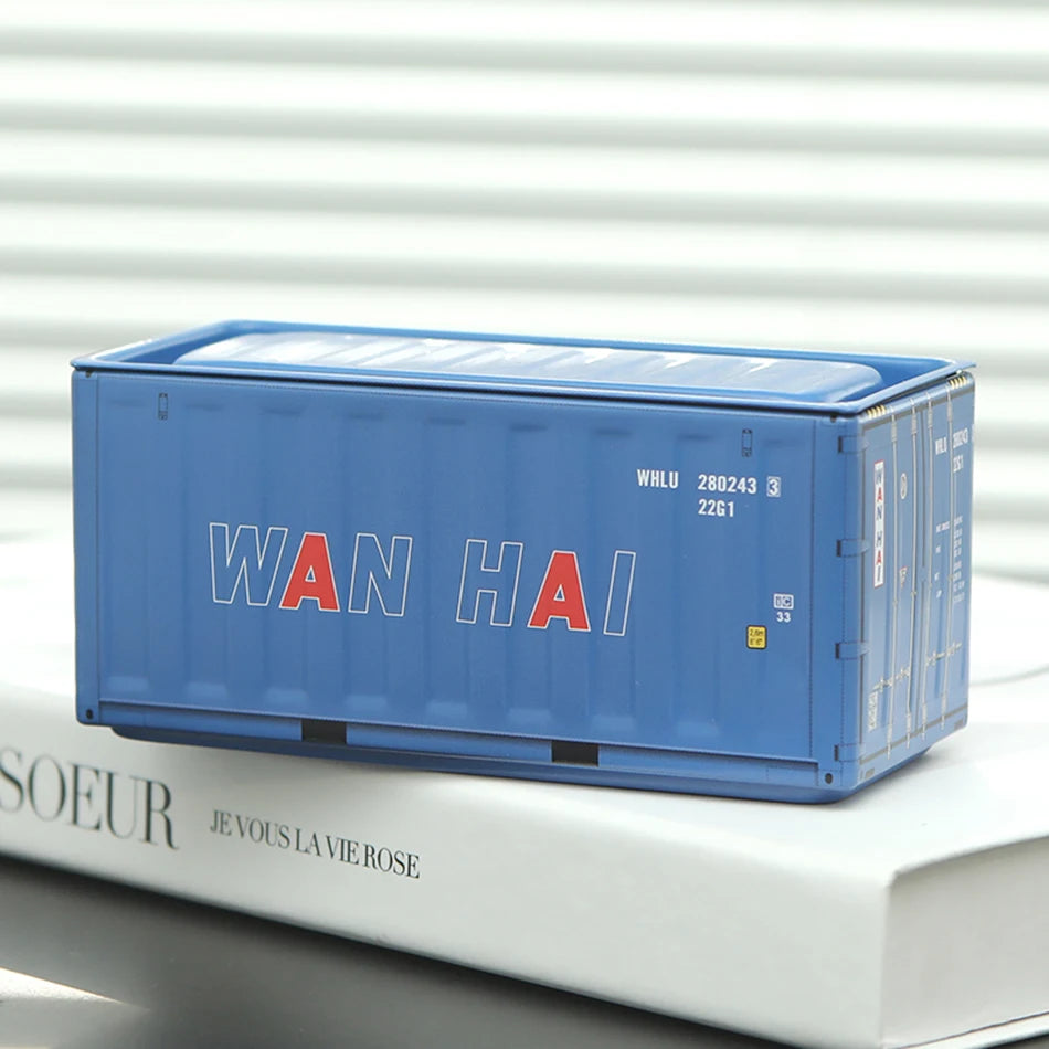 A blue industrial storage box labeled WAN HAI resting on a white book.