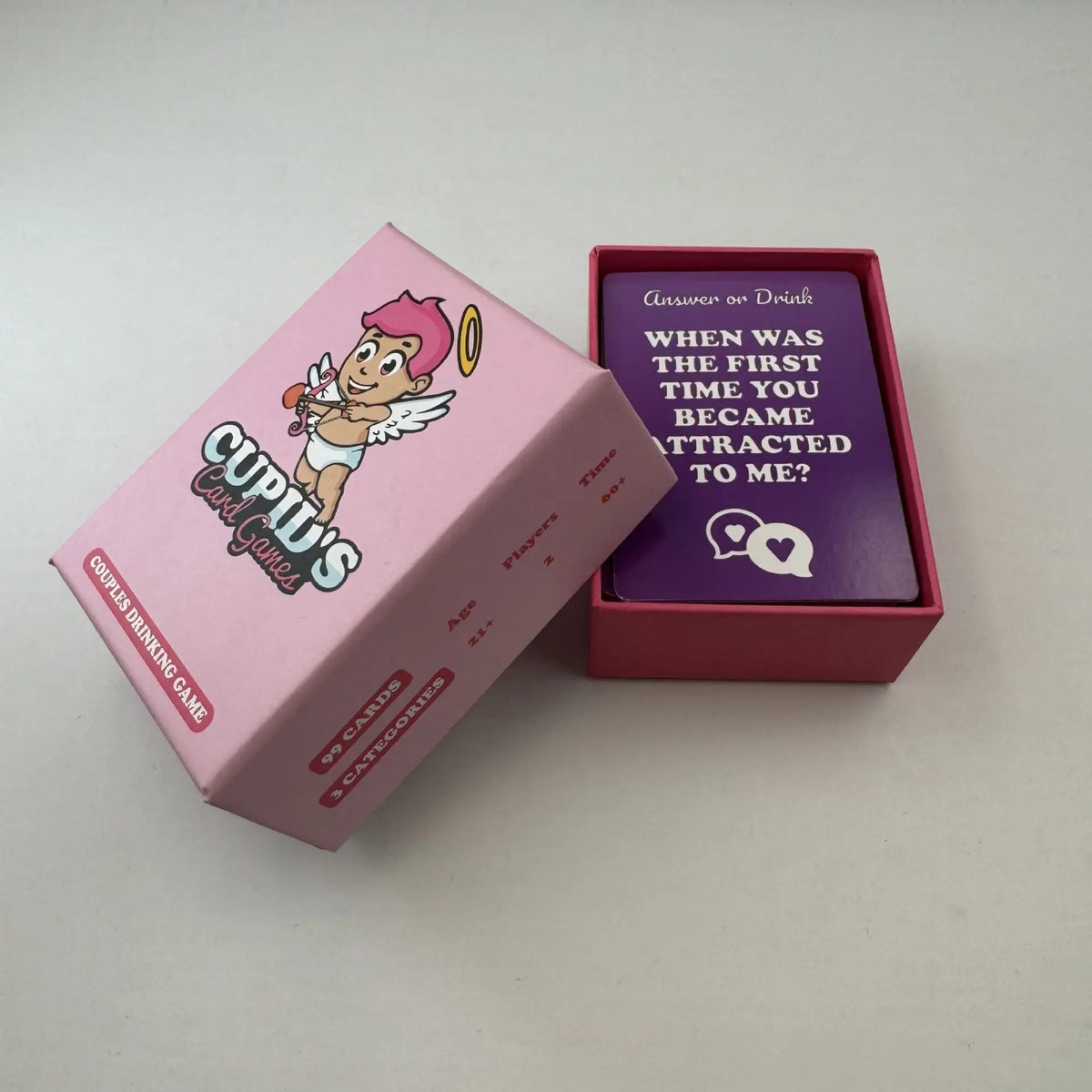 A pink box of Cupid's Card Games and a red box labeled Answer or Drink, both for an interactive couples drinking game.