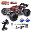 A black and red brushless 4WD monster truck RC car with large tires and accessories.