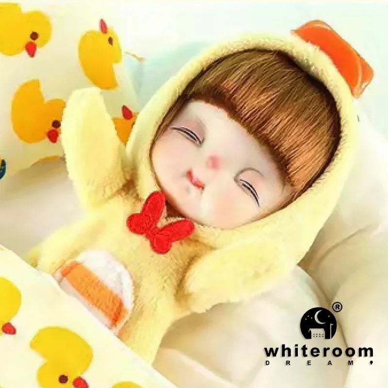 A yellow plush doll with brown hair and orange accents is shown in a close-up against a white background.