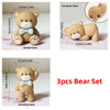 A set of three tan bear figures including a seated, lying down, and standing pose for birthday or baby shower decorations