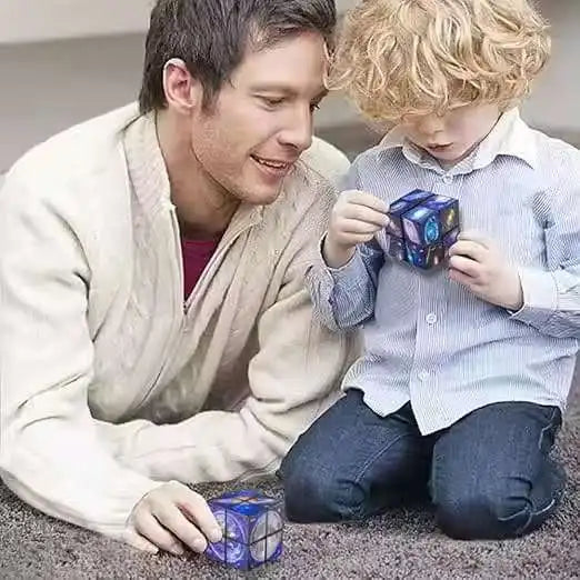 A man and a young boy are playing with a blue magic cube puzzle toy.
