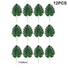 Twelve artificial tropical palm leaves on green stems for party decoration
