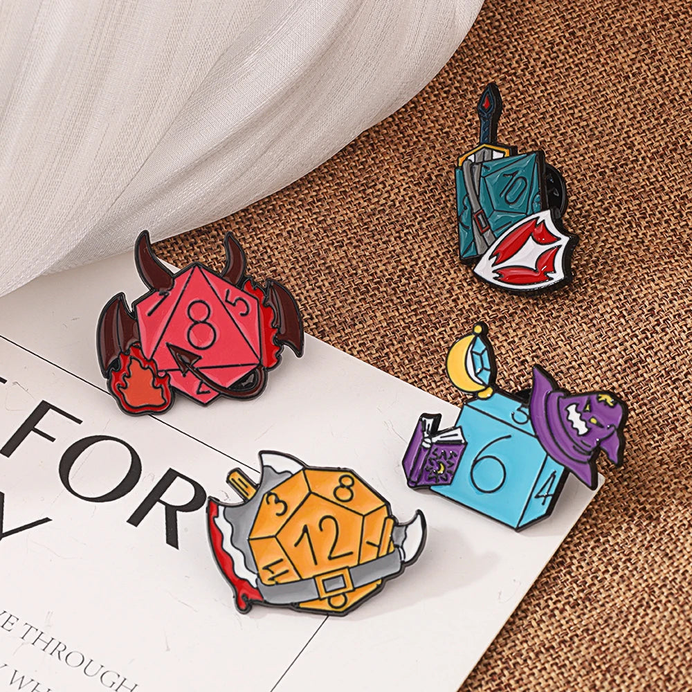 A set of enamel pins featuring dragon dice designs in various colors and shapes on a brown textured background.