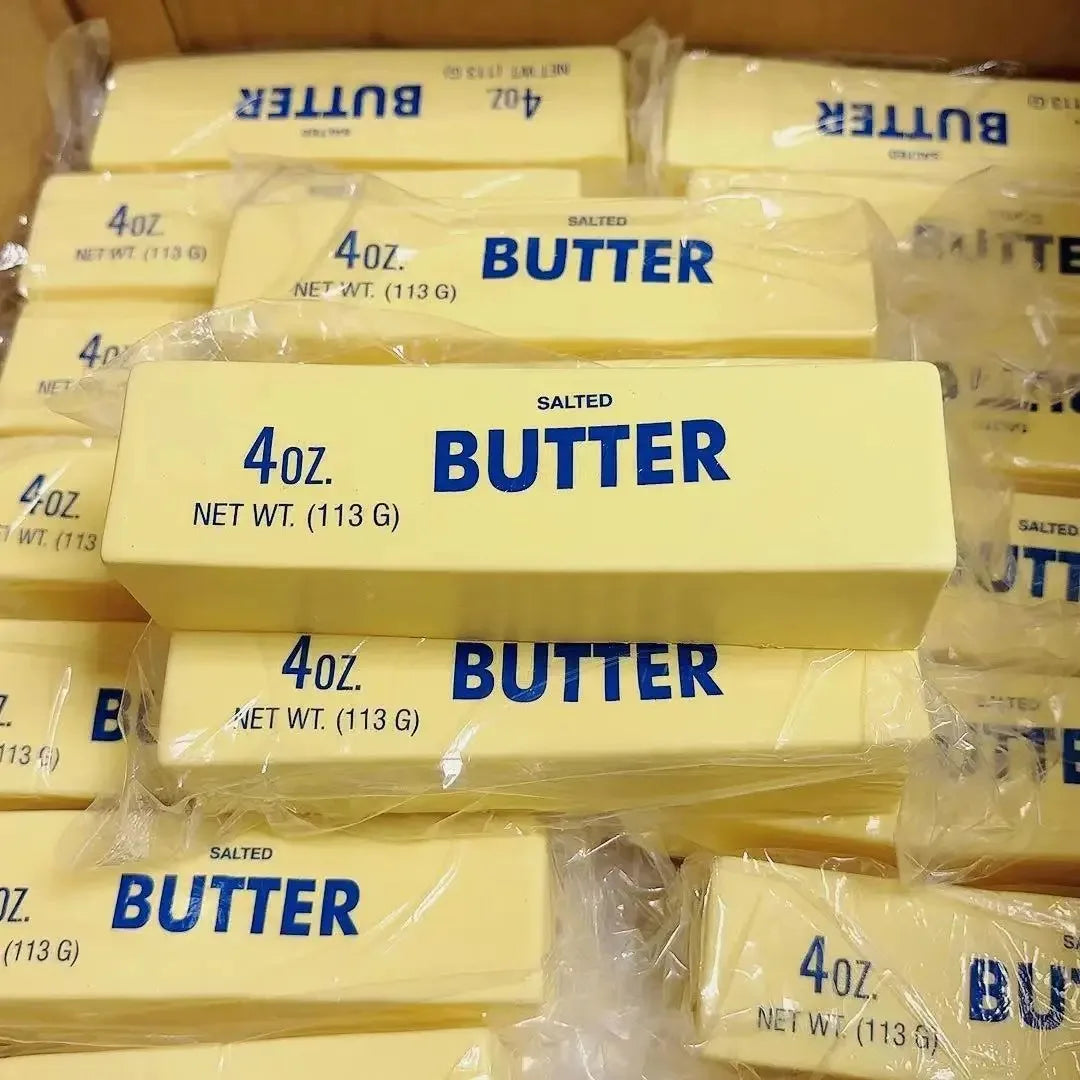 A collection of yellow butter squishy toys packaged in clear plastic bags.