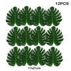 Twelve artificial tropical palm leaves, dark green, measuring 17x21 cm each.