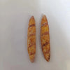 Two miniature baguette loaves used for dollhouse kitchens