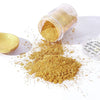 A jar of gold mica pearl powder next to a pile of the same golden glitter powder on a white surface.
