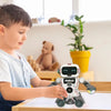 A boy is interacting with a white Digibot robot toy on a wooden surface.