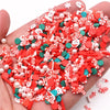 A pile of red and white polymer clay slices assorted for DIY crafts is held in a hand.