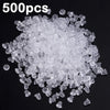 A pile of clear silicone earring backs for secure stud closure.