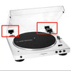 A white audio turntable with its lid open, showing the dust cover hinge mechanism.