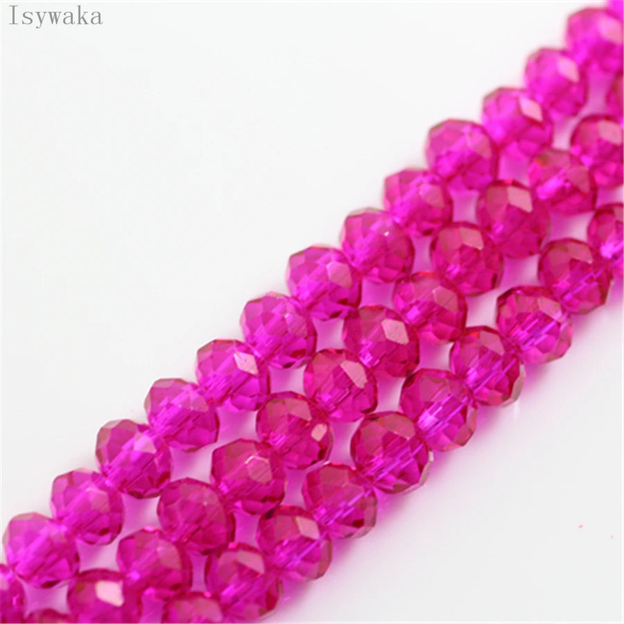 A close-up of pink crystal glass beads arranged in a strand for jewelry making.