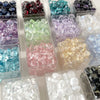 Assortment of geometric glass beads in various colors including purple, green, pink, and clear shades for jewelry making