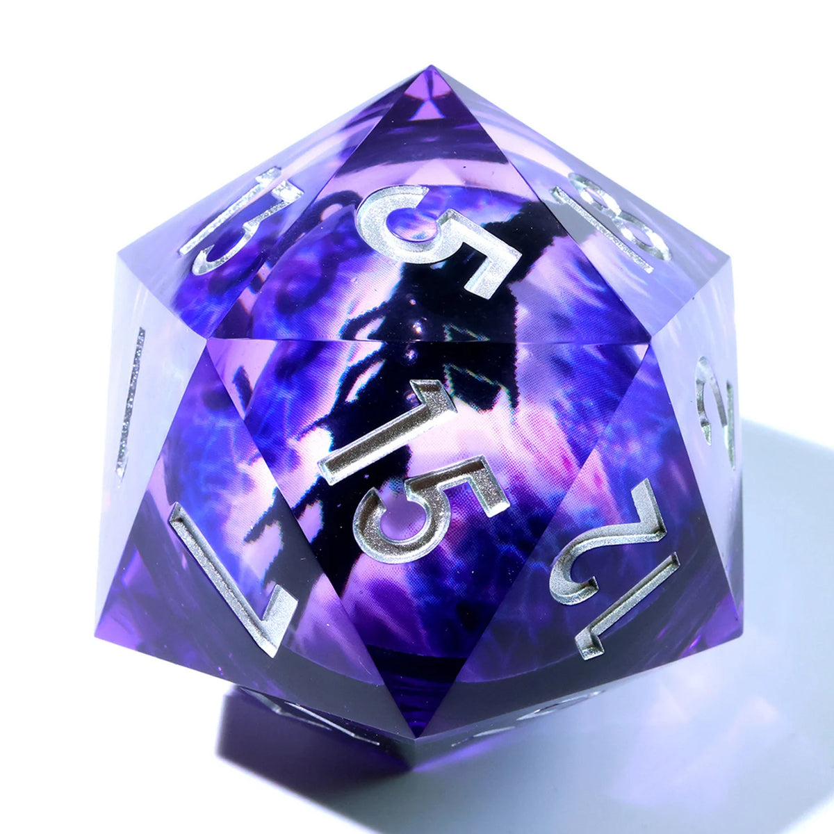 A handmade resin D20 die with a large purple and blue liquid swirl pattern.