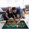 A man and an older man are looking at a colorful jigsaw puzzle spread on a white rug.