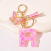 Gold initial heart keychain featuring a pink butterfly charm and a clear pink initial letter.