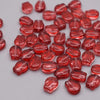 A pile of translucent red glass beads shaped like tulip flowers.