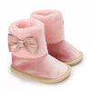 Pink plush baby snow boots for girls and boys with a glitter bow