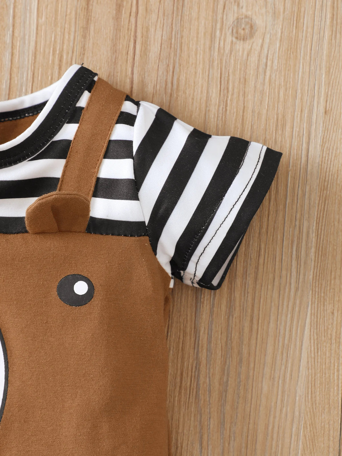 A brown romper with a black and white striped short sleeve top and matching tan overalls.