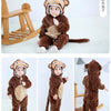 A brown animal hooded romper for a baby sitting on a white surface.