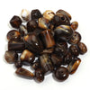 A pile of dark brown and amber colored acrylic beads for jewelry making