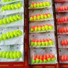 A collection of oval fishing floats with bobber beads in various colors, packaged for sale.