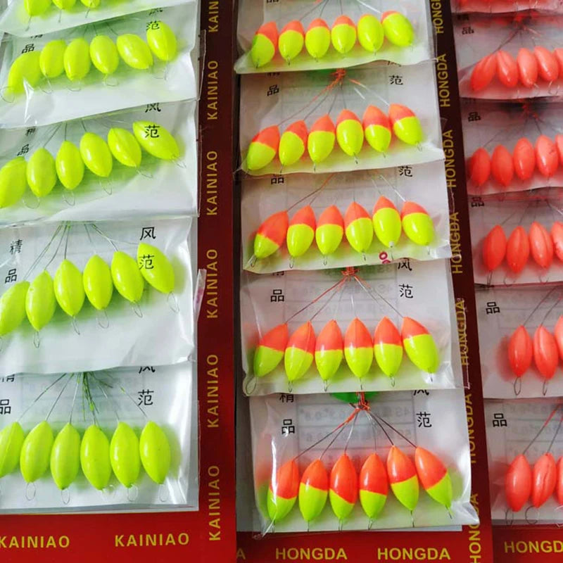 A collection of oval fishing floats with bobber beads in various colors, packaged for sale.