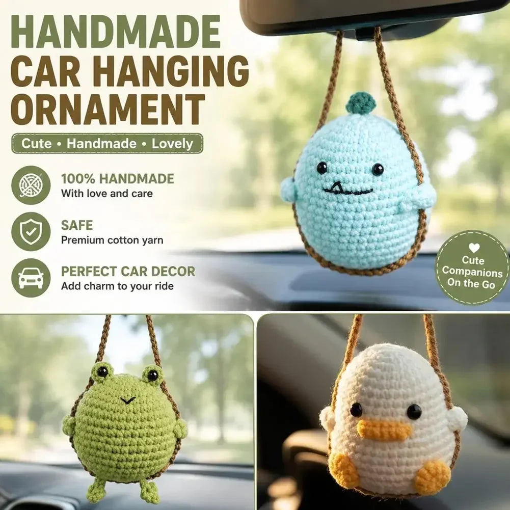 A light blue crocheted sea creature ornament hanging from a string, displayed in a car interior.