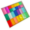A tray of rainbow acrylic building blocks in various bright colors arranged in a grid.