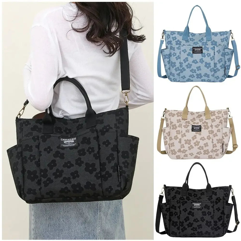 Three floral canvas tote bags in black, light blue, and beige displayed against a white background.