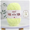 A ball of light green chenille yarn labeled with Chinese characters for knitting and crochet.