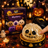 A golden, pumpkin-shaped squishy stress relief toy is displayed in a dark Halloween themed box surrounded by seasonal decor.