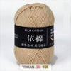 A ball of light beige milk cotton yarn labeled YIMIAN 18 for knitting and crochet.