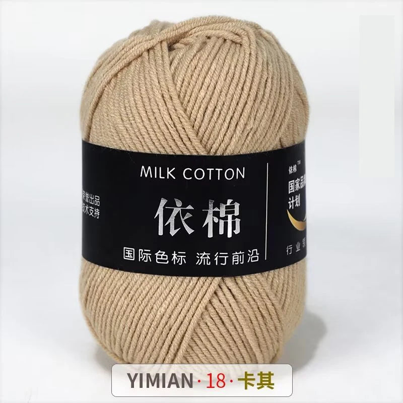 A ball of light beige milk cotton yarn labeled YIMIAN 18 for knitting and crochet.