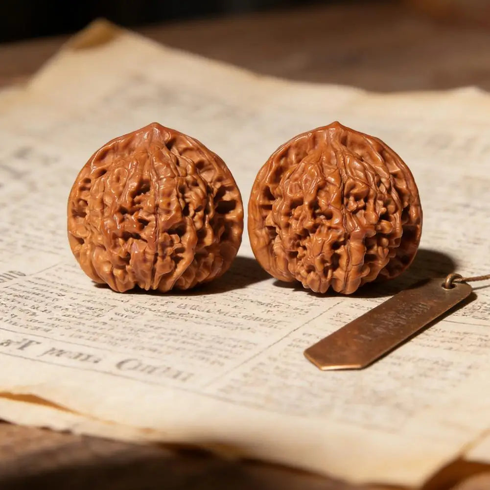 Two hand-polished brown walnuts resting on aged paper.