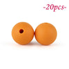 Two round, orange silicone beads are shown against a white background.