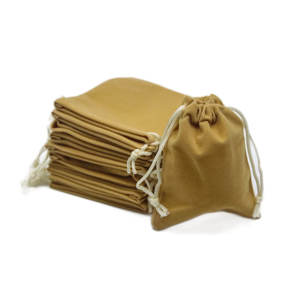 A stack of tan drawstring dice bags for tabletop games.