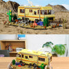 A detailed building block set of a yellow RV camper bus with desert scenery and cacti.