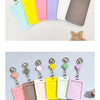 A collection of colorful retractable ID badge holders with keychains and clips arranged in a row.