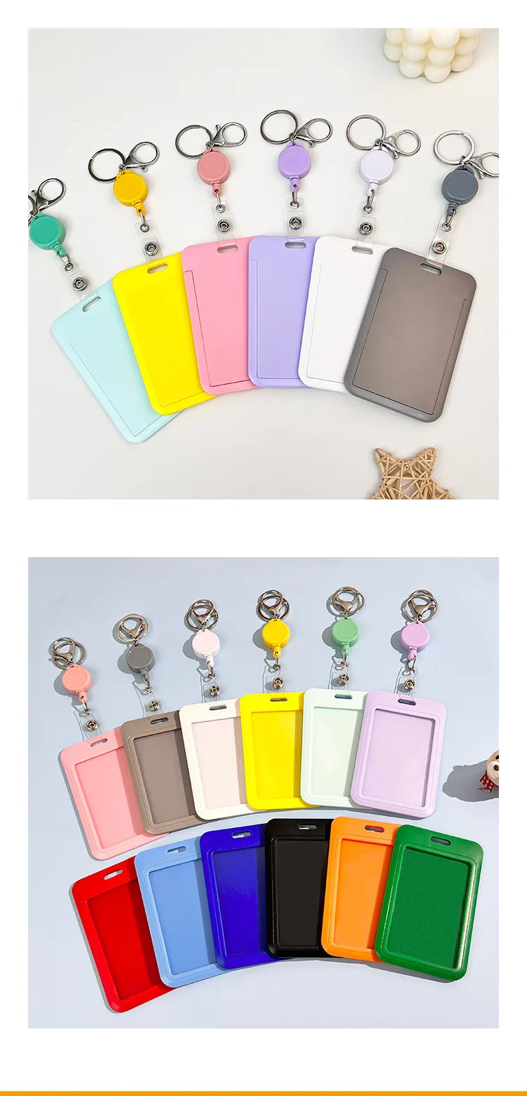 A collection of colorful retractable ID badge holders with keychains and clips arranged in a row.