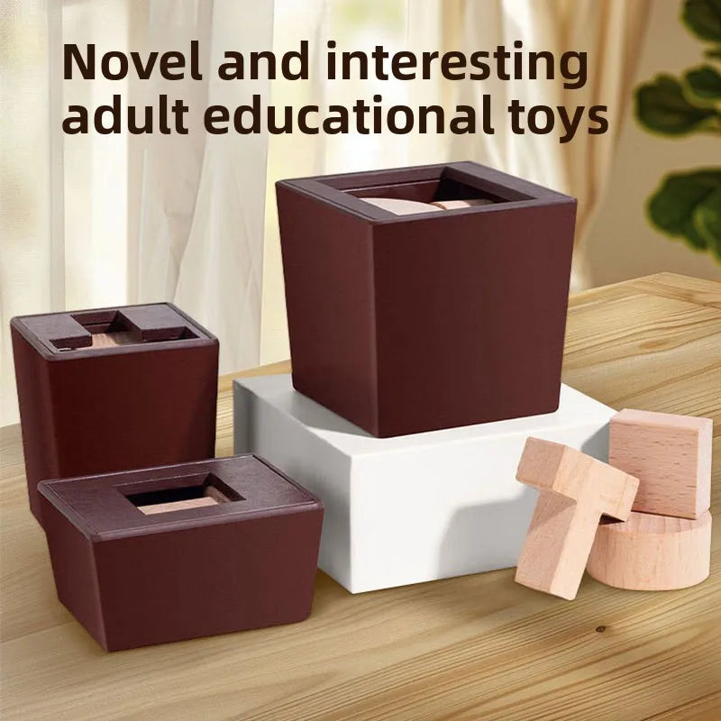 A brown wooden magic box puzzle with a white base and loose wooden blocks is displayed on a light wood surface.