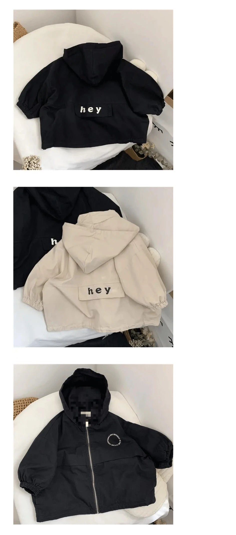 A black hooded zip-up jacket with a white text print on the chest and a beige version of the same jacket.