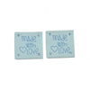 A set of two light blue embossed leather labels for sewing and crafts, each engraved with Made with love.
