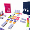 A collection of colorful wooden tiles and a dark blue bag for a variety board game set.